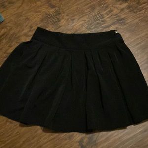 Black skirt, 2 buttons on the side w zipper. Size M